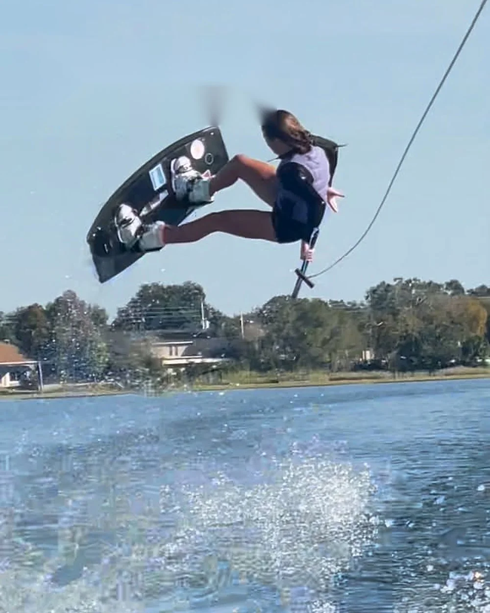Ashley Kazmer grabbing her board high above the wake, in a clip shared with Glen Fletcher