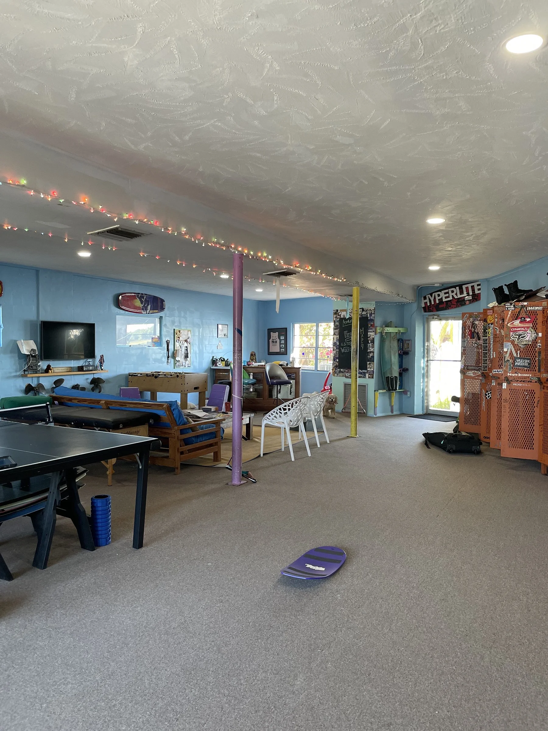 The downstairs lounge with a table-tennis table and board racks