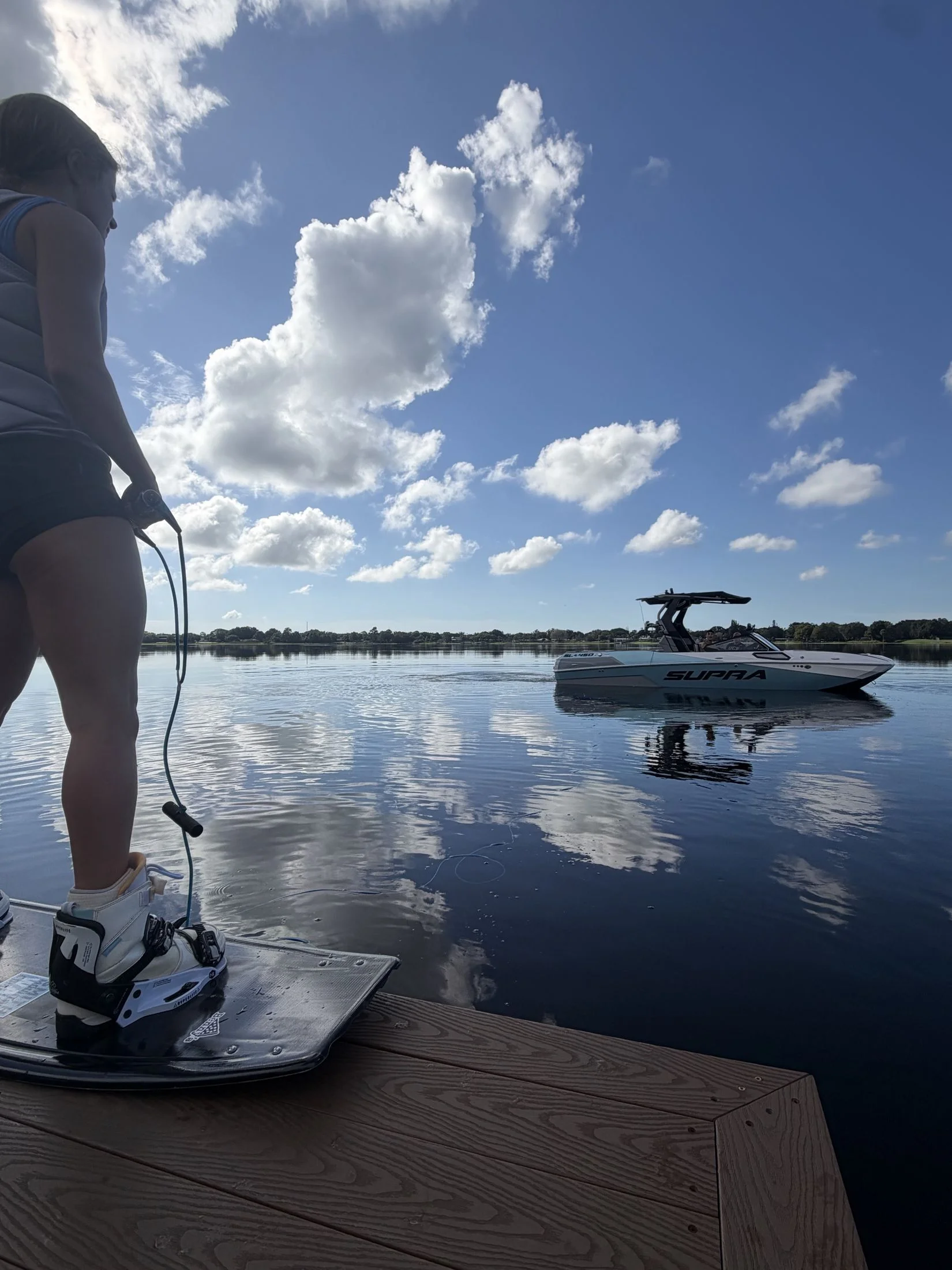 A rider on the dock with the Supra SL 450 waiting on Lake Barton